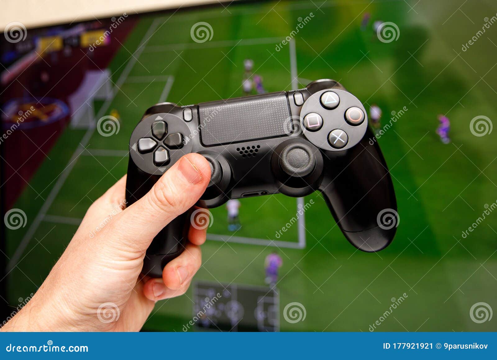 Man Playing Computer Football or Soccer Game at Home