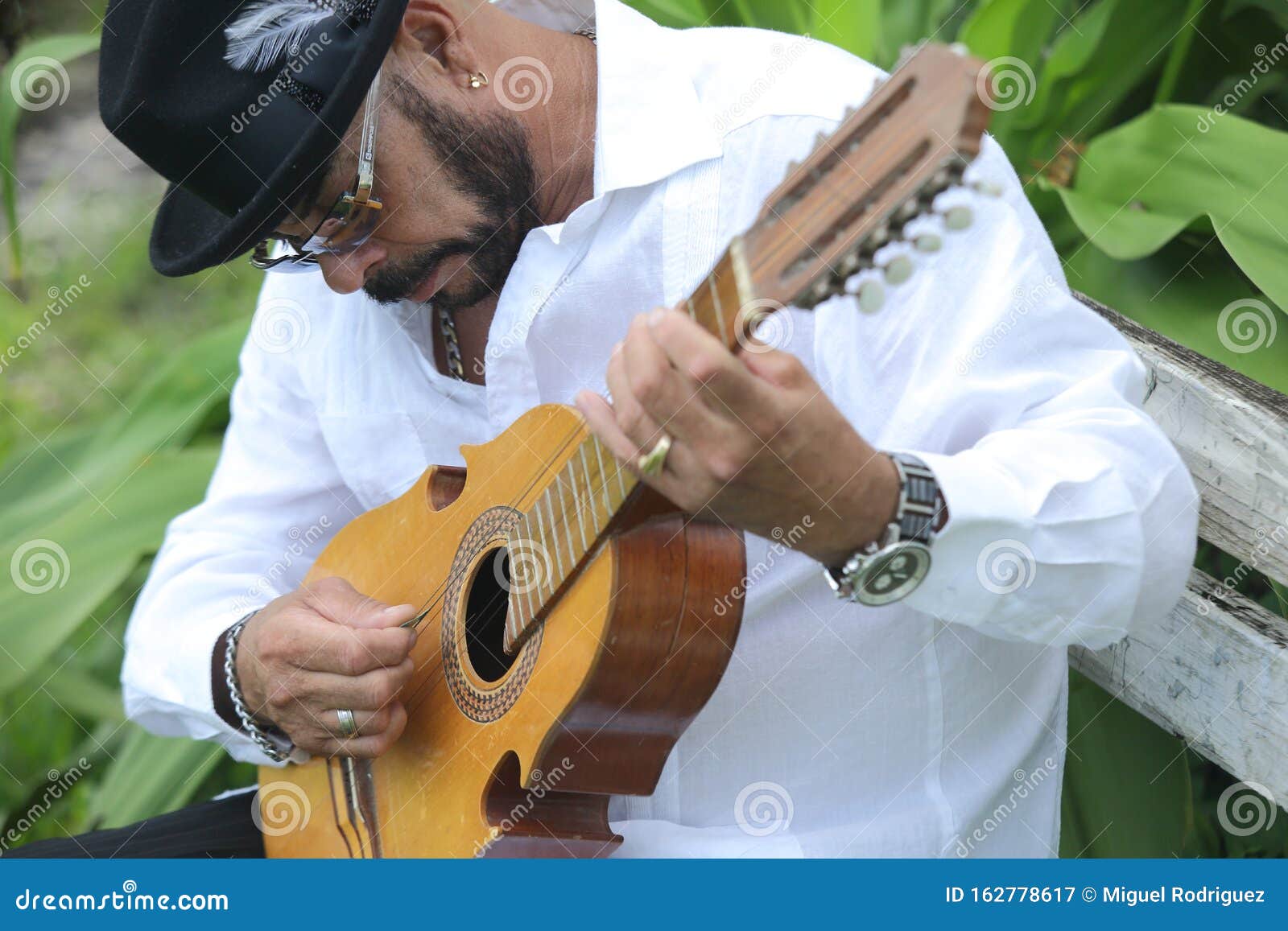 a man playing a folk song in the puerto rican cuatro