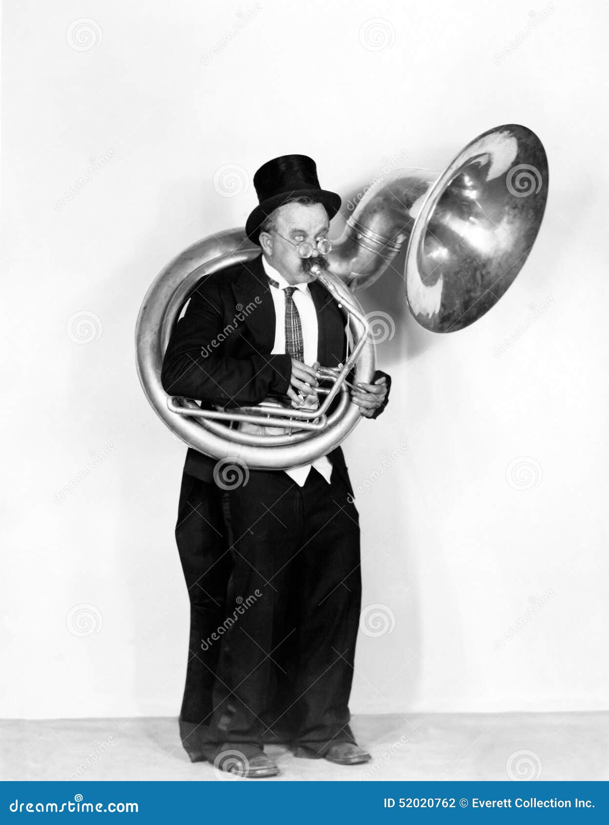 man playing a tuba in a top hat