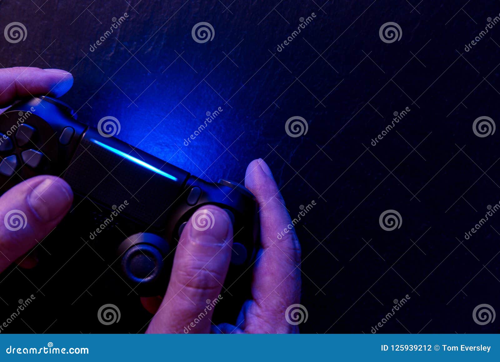 Man Playing Video Game with Controller at Night Lights Stock Photo Image of background