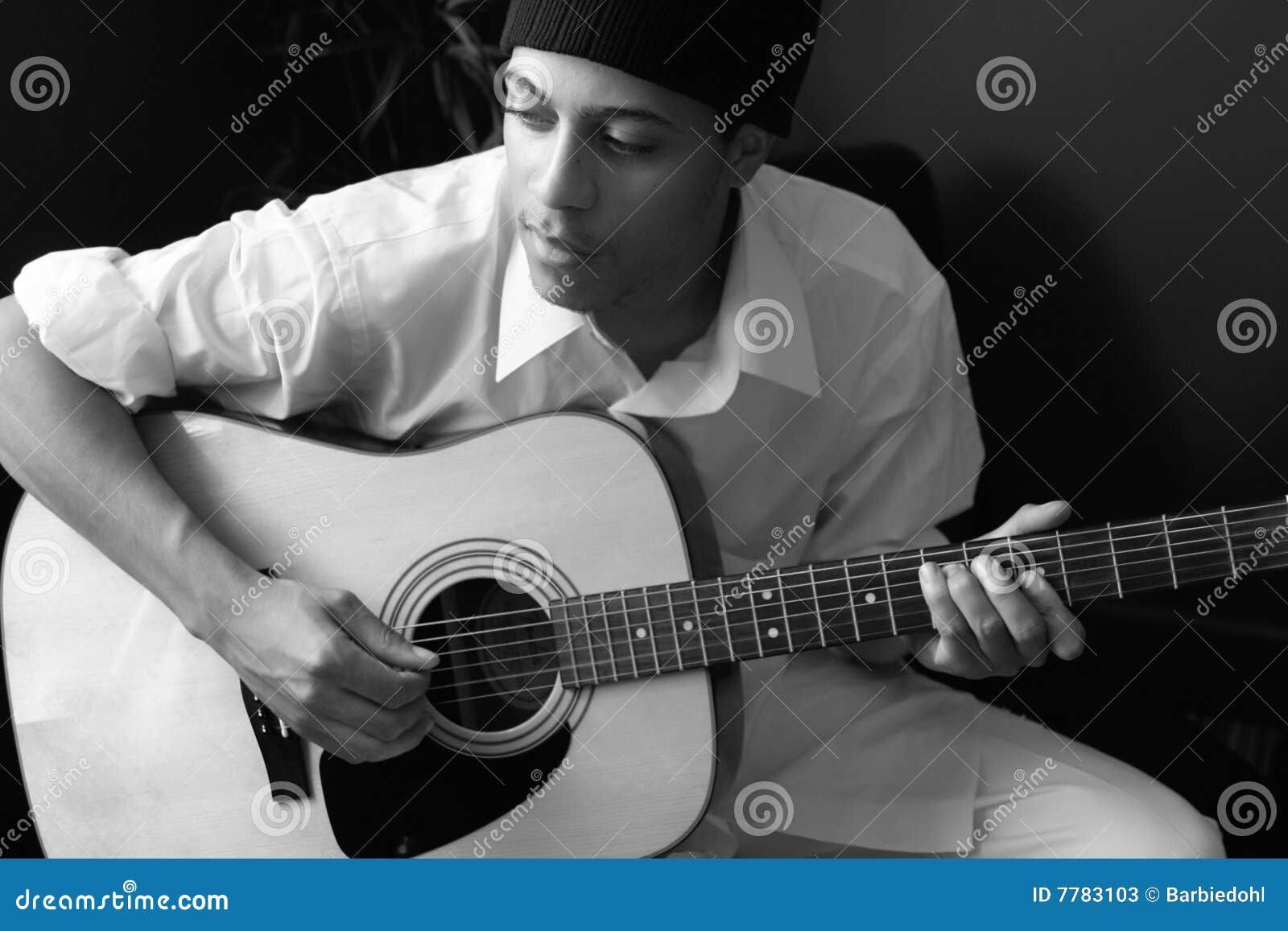 man plays acoustic guitar