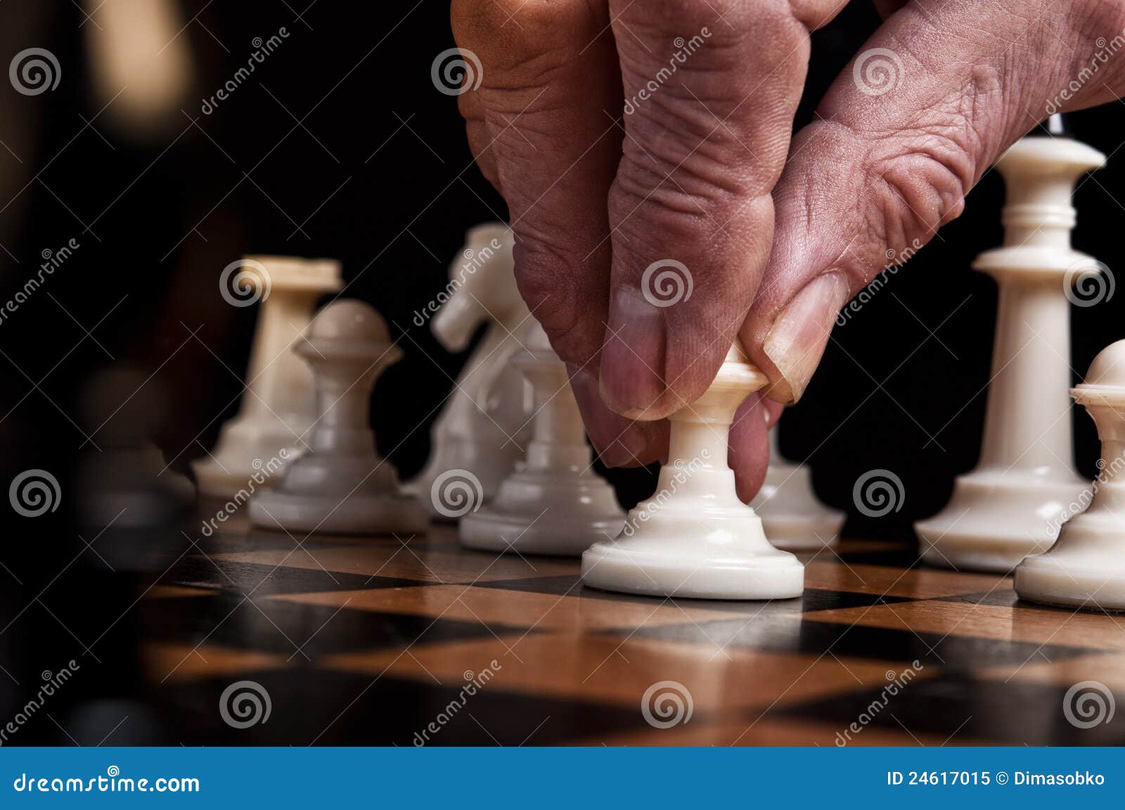 Hand Of A Man Taking A Chess Piece To Make The Next Move In A Chess Game.  Close Up. Spring Day Outside. Stock Photo, Picture and Royalty Free Image.  Image 198493516.