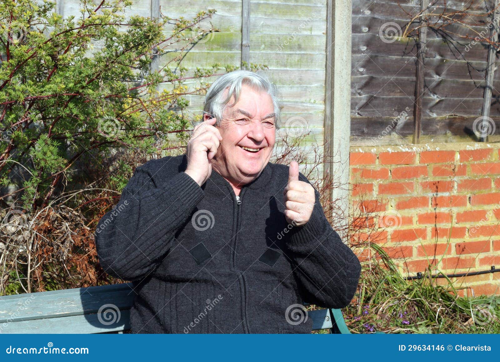 man pleased with his mobile phone converstation .