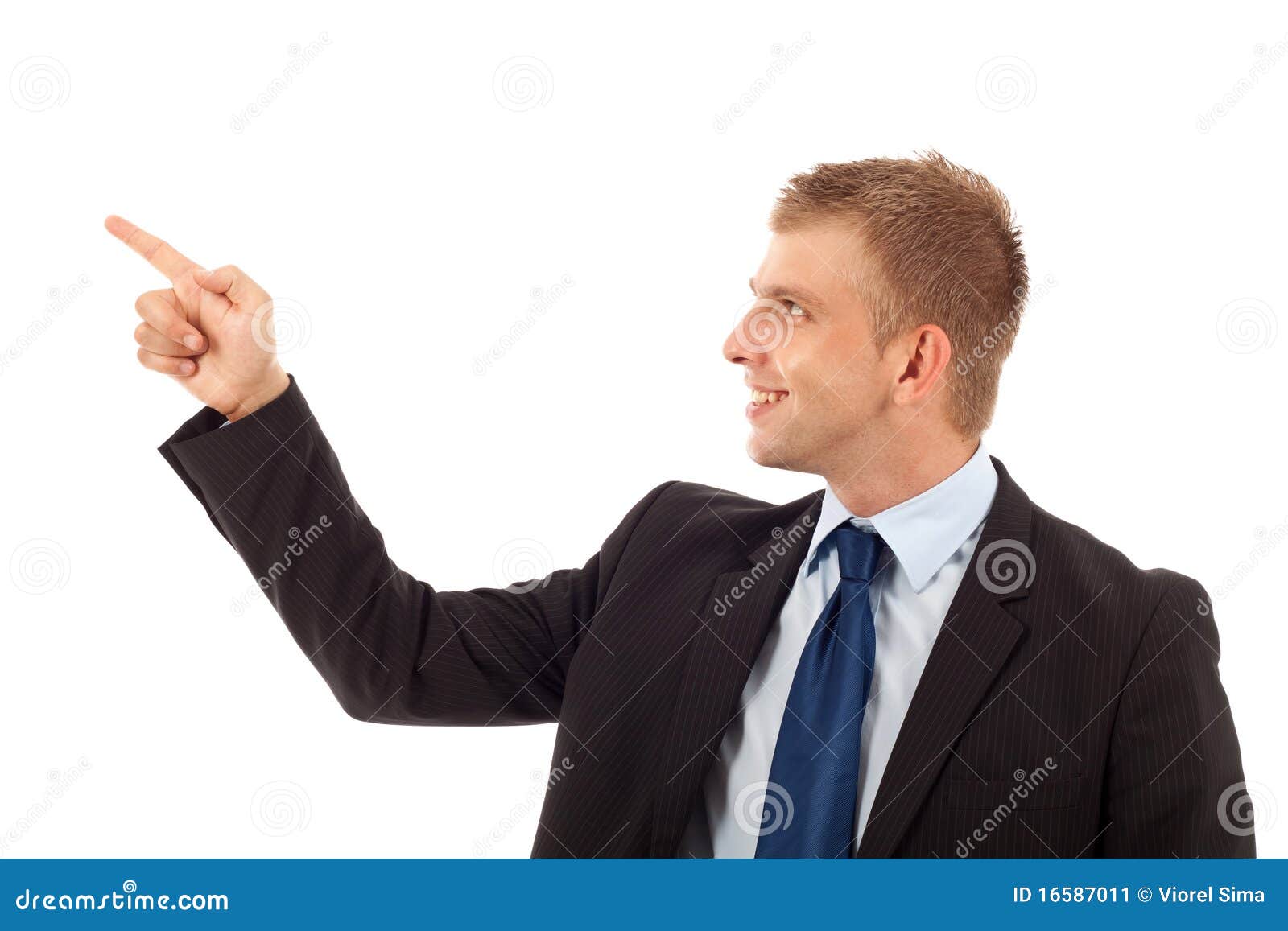 Young smiling business man pointing on something. Isolated.