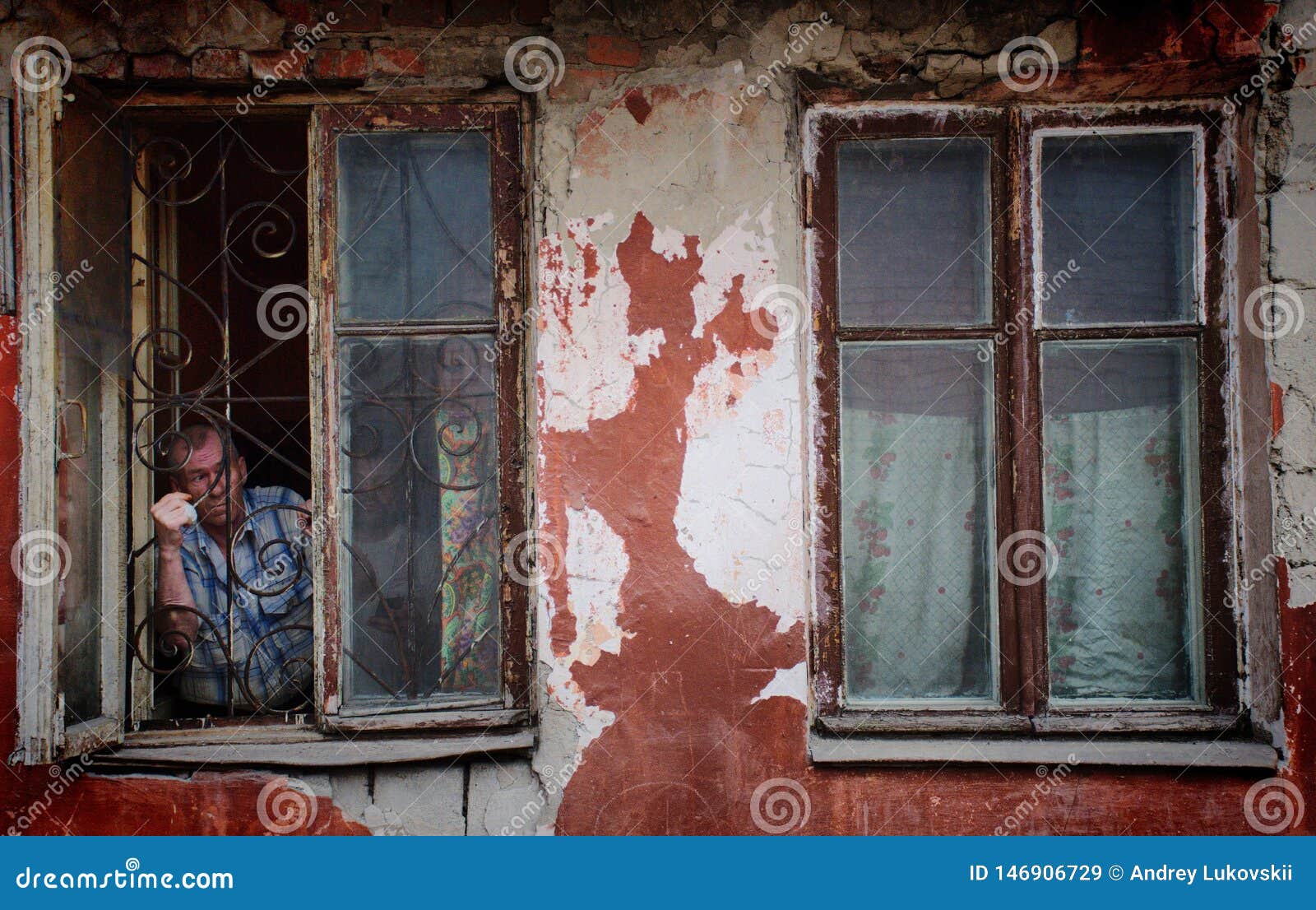 A Man in a Poor Quarter Looking Out the Window of an Old House ...