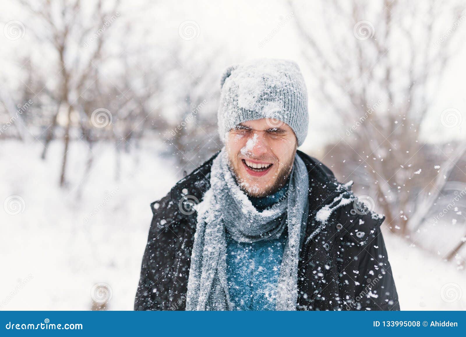 Surprised Man Feeling Cold Snowflakes on His Face during a Snow Stock ...