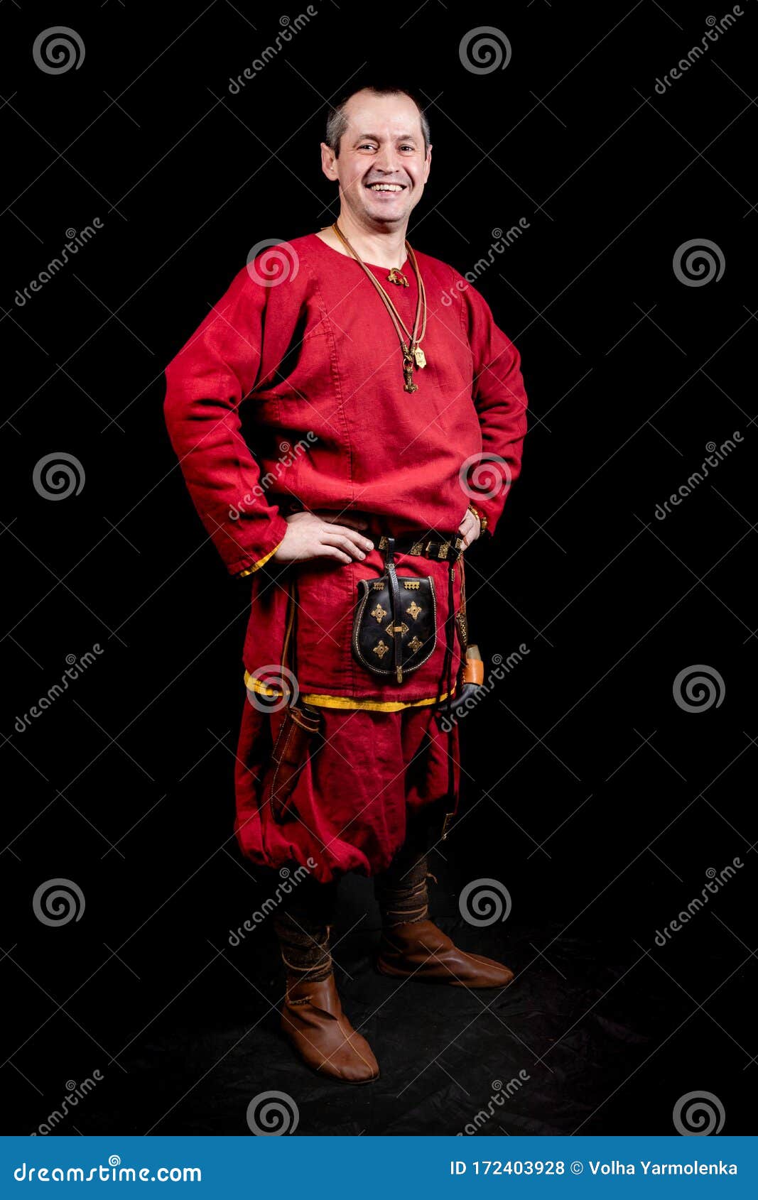 A Poses in Ancient Clothing: a Red Shirt, Pants, Jewelry, Ancient Shoes. Man Smiling Stock - Image of early, fashion: 172403928