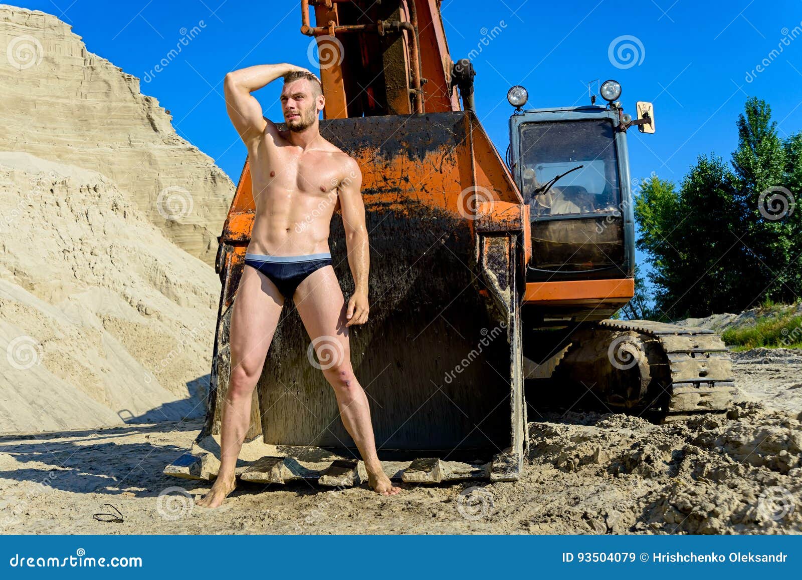 Man Posing in a Bathing Suit on a Background of a Bulldozer Stock Image -  Image of confident, muscles: 93504079