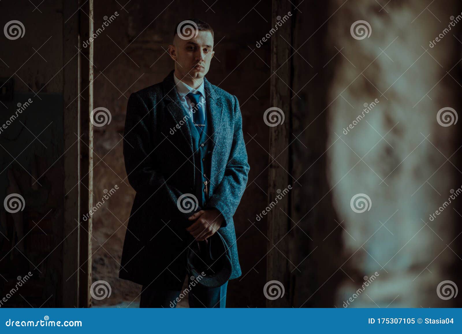 a man posing in the image of an english retro gangster in peaky blinders style