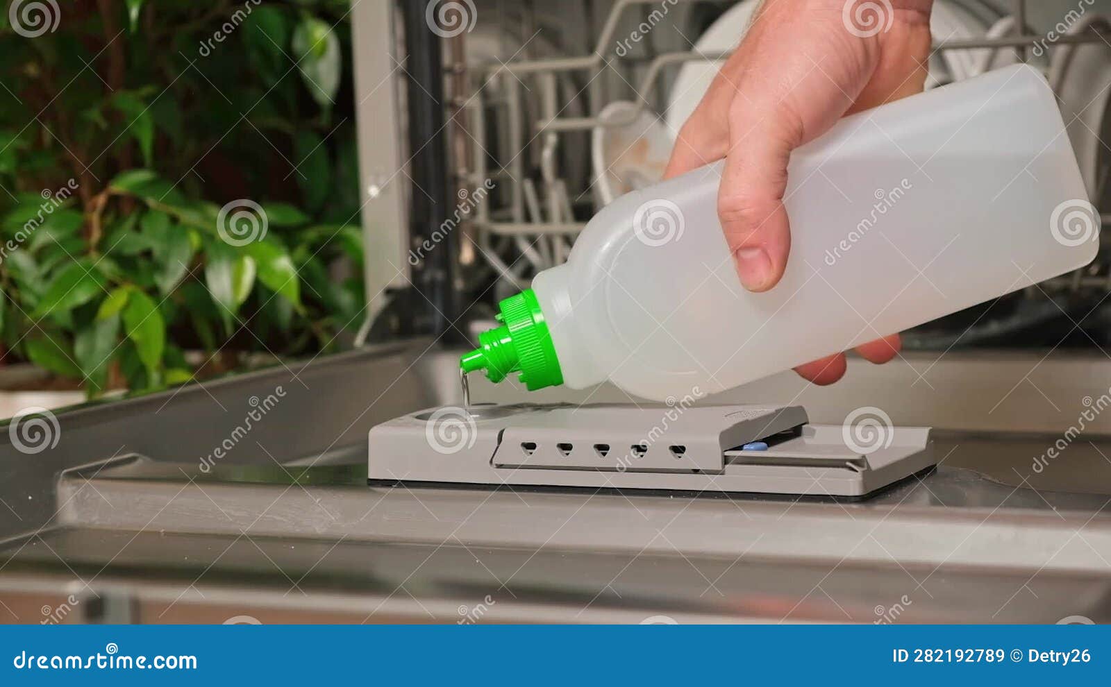 A Man Pours a Rinse Aid into Dishwasher Compartment. Stock Video