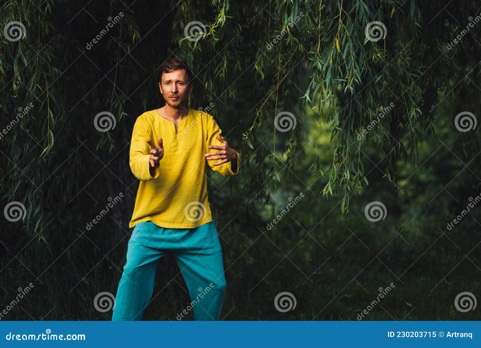 man practicing neigong in nature near the foliage