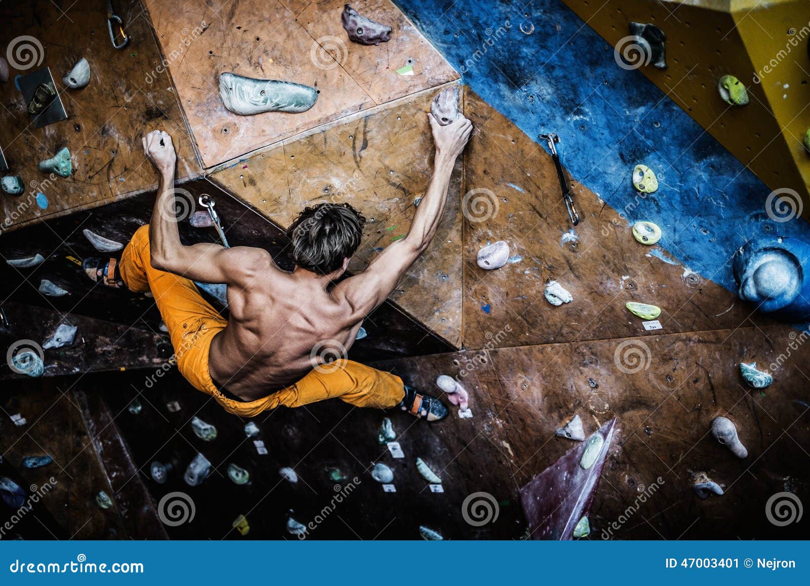 man practicing rock-climbing on a rock wall