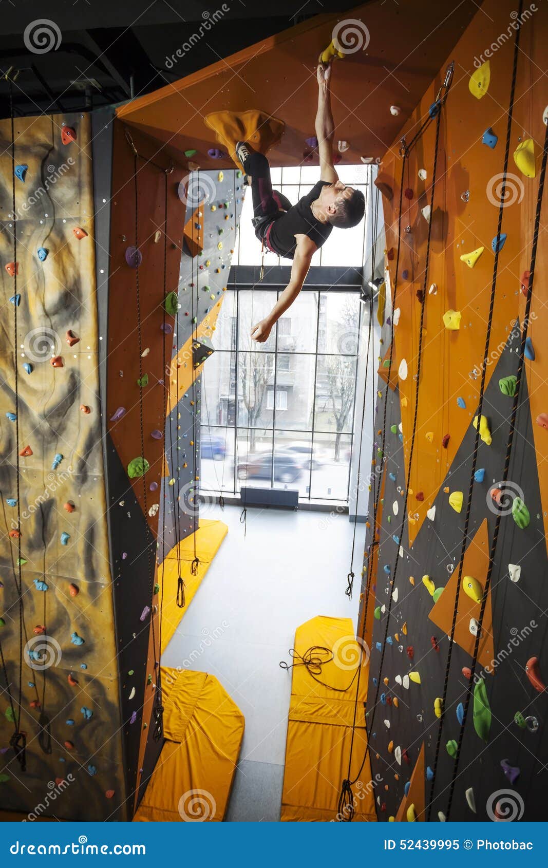 Man Practicing Top Rope Climbing in Climbing Gym Stock Image