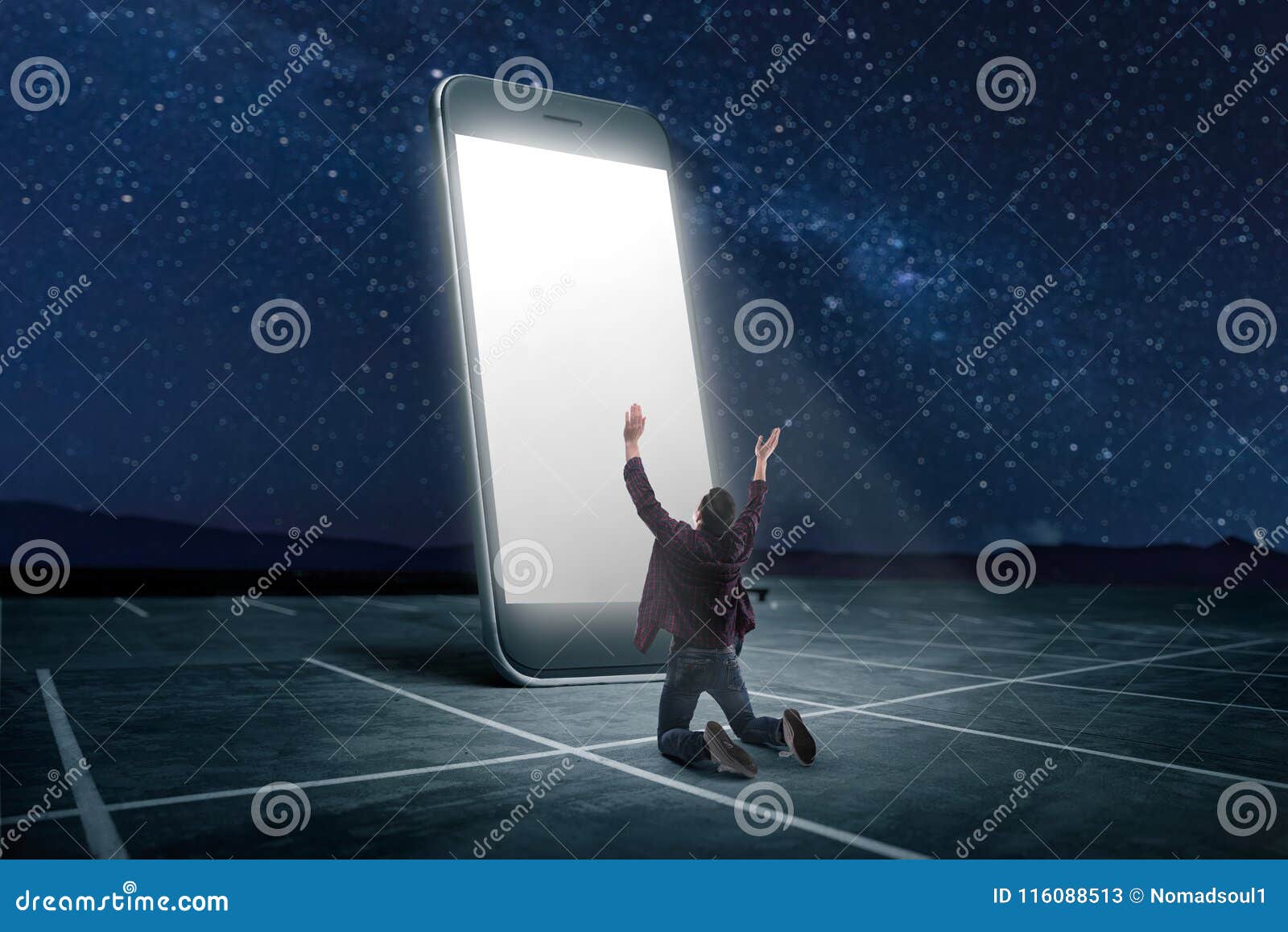 man praying on his knees against large smartphone