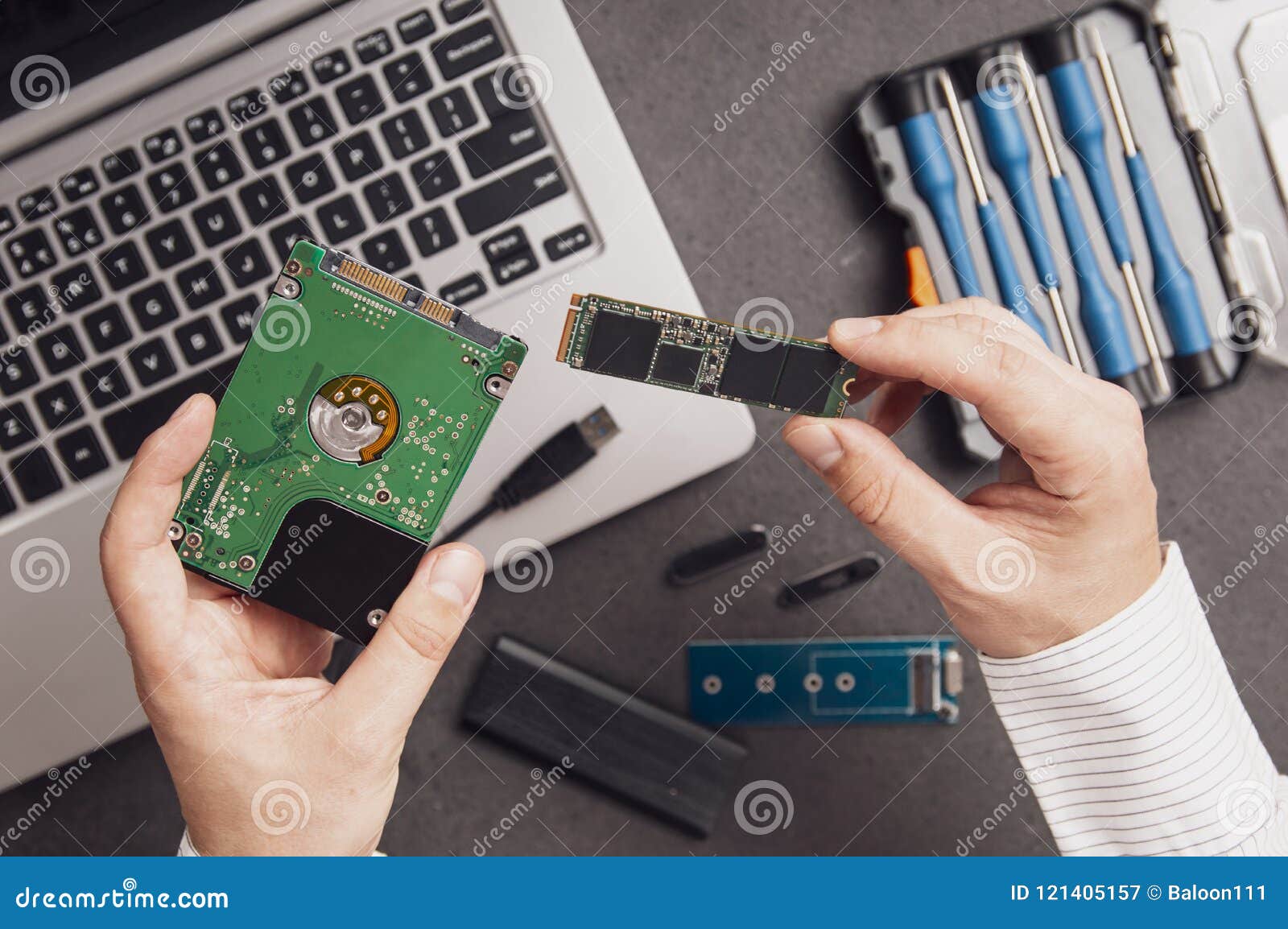man prepares to replace an old hdd drive with a modern m.2