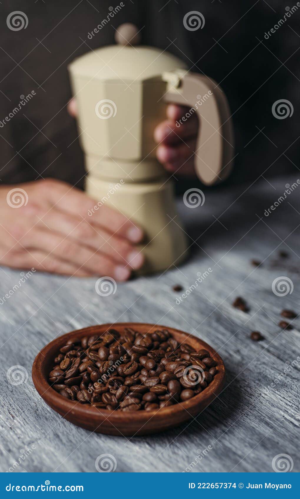 man is preparing coffee in a beige moka pot