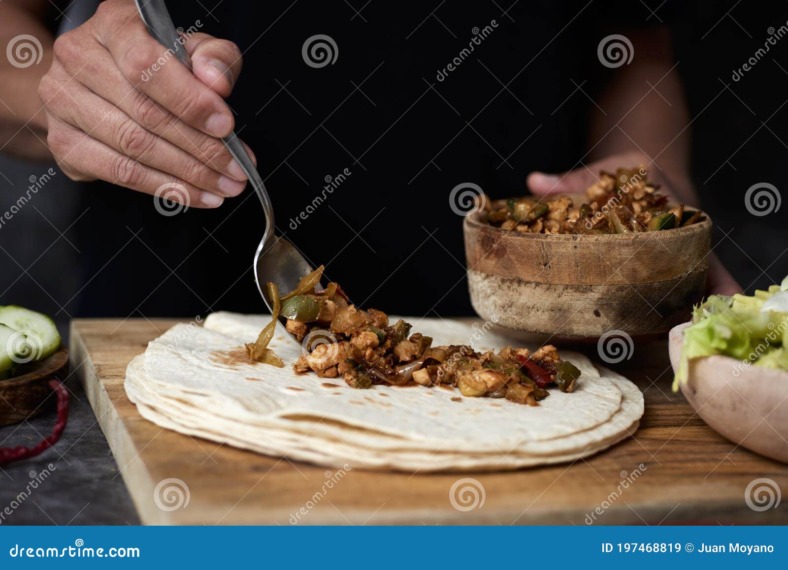 man preparing a durum or a burrito