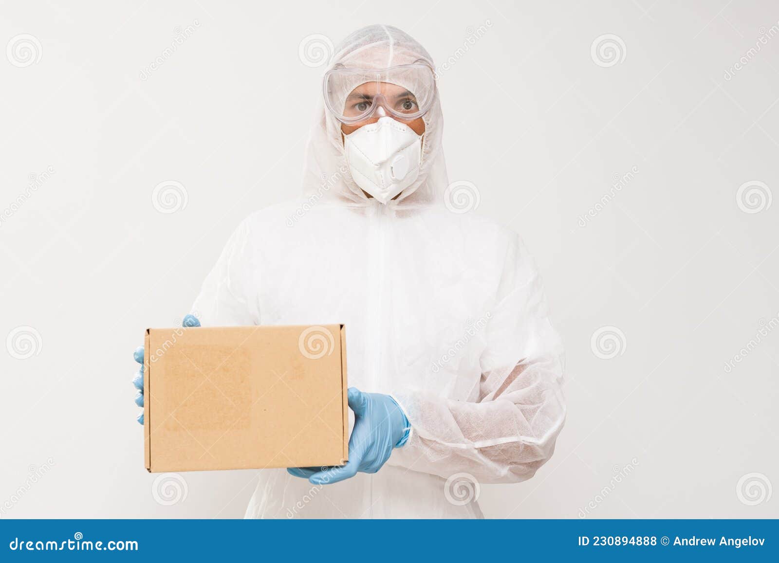 Man in Protective Suit and Mask with Box in His Hands Stock Photo