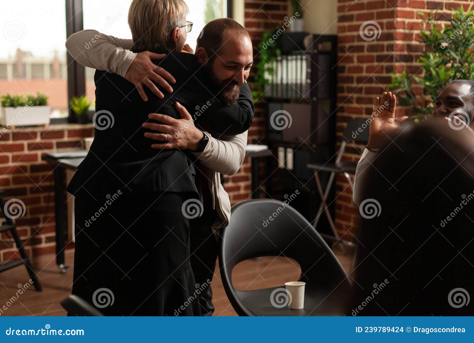 man and psychologist hugging after sharing addiction progress with aa meeting group
