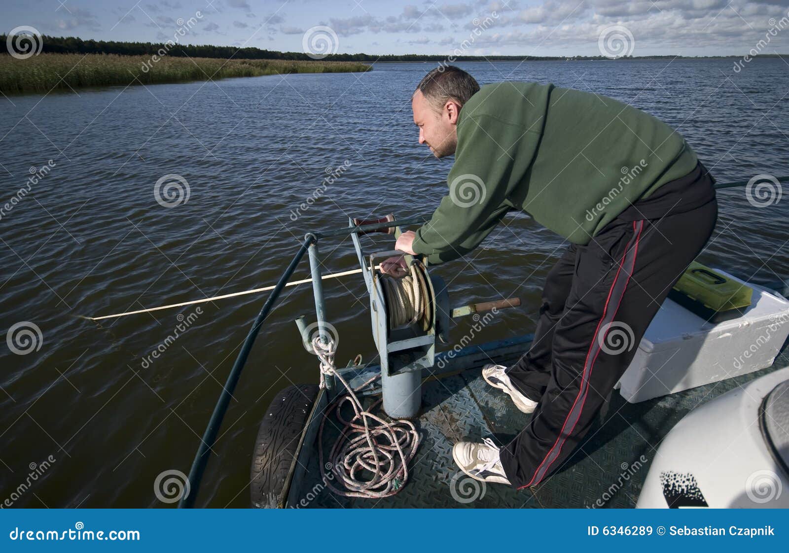 Man pulling anchor rope stock image. Image of water, strong 6346289