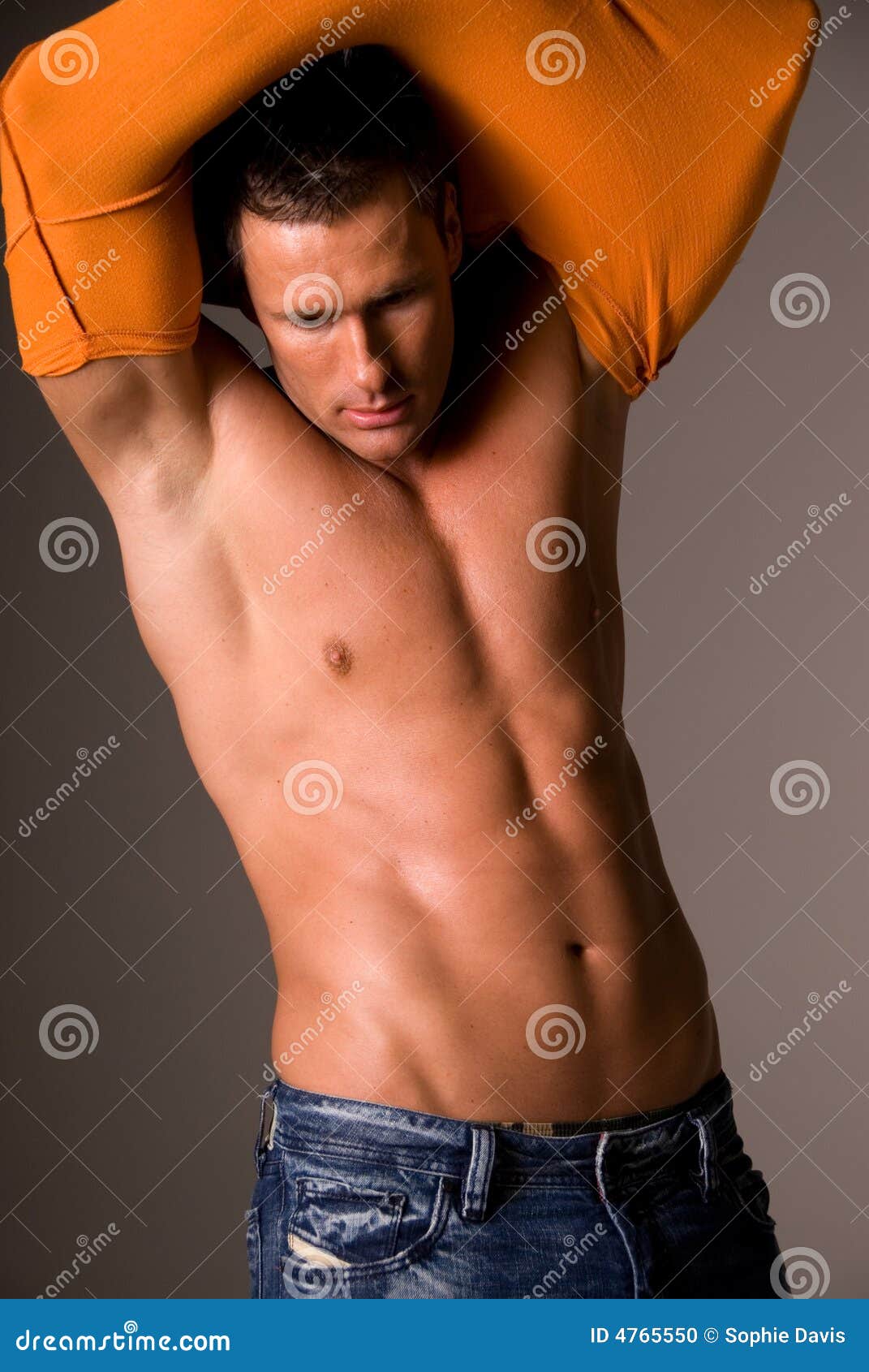 Man pulling off tshirt. stock photo. Image of tight, studio 4765550