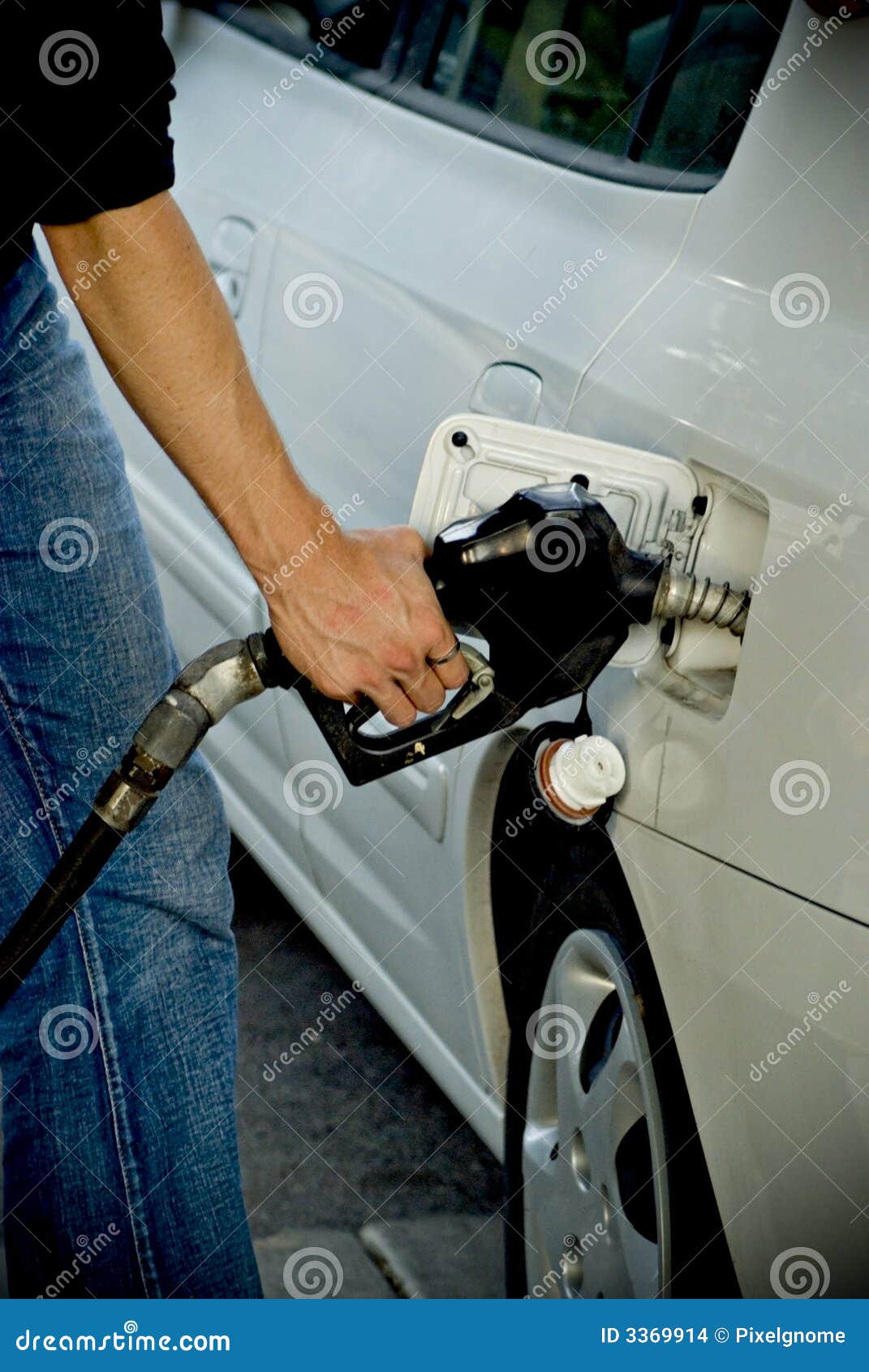 man pumping gas into car