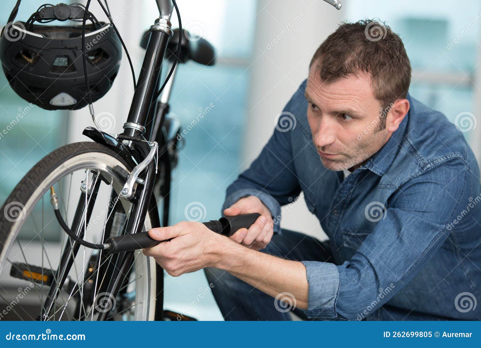 Man pumping up bike tire stock image. Image of pumping 262699805