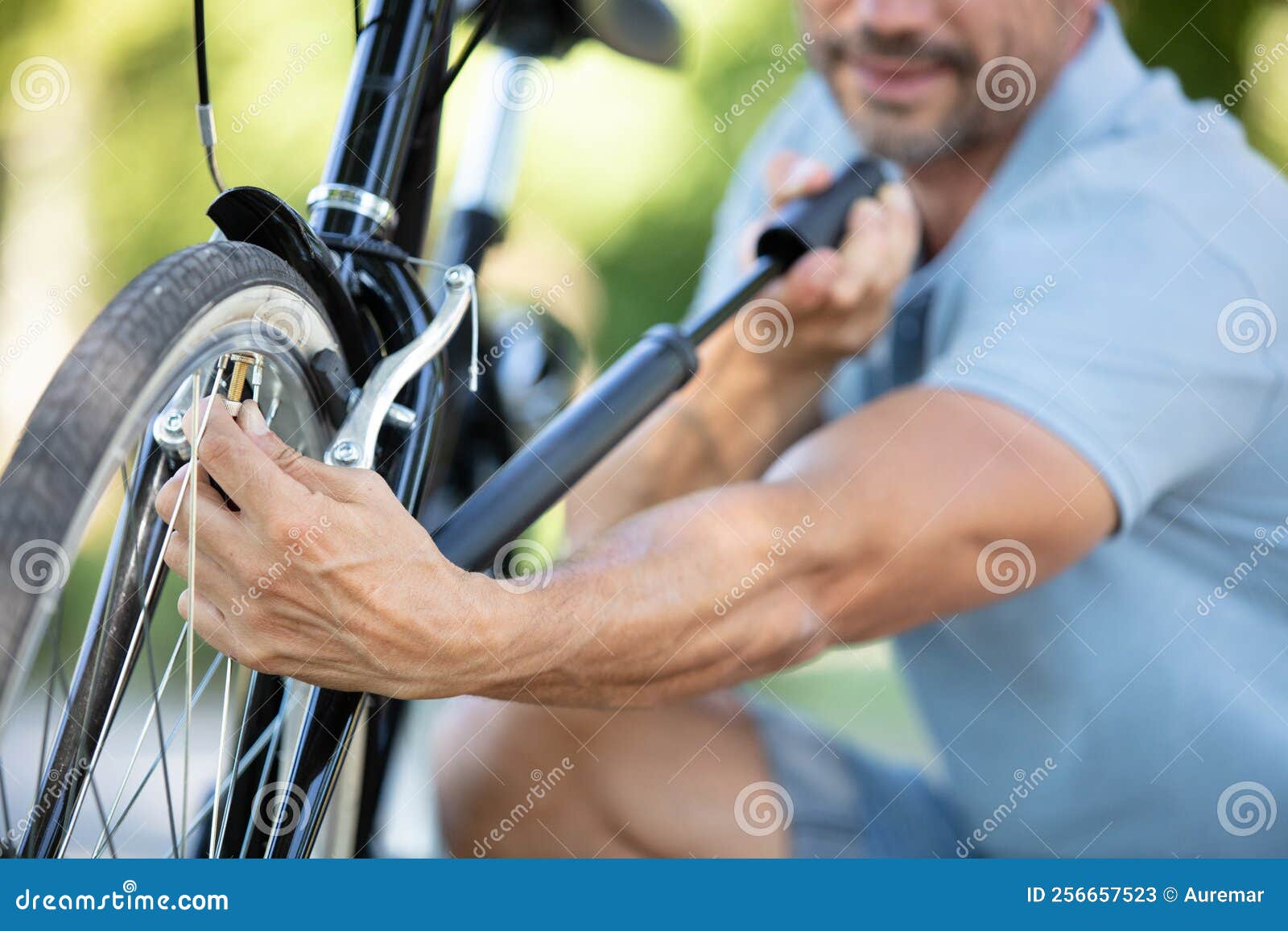 Man Pumping Up Bike Tire Using Pump Stock Image Image of outdoors