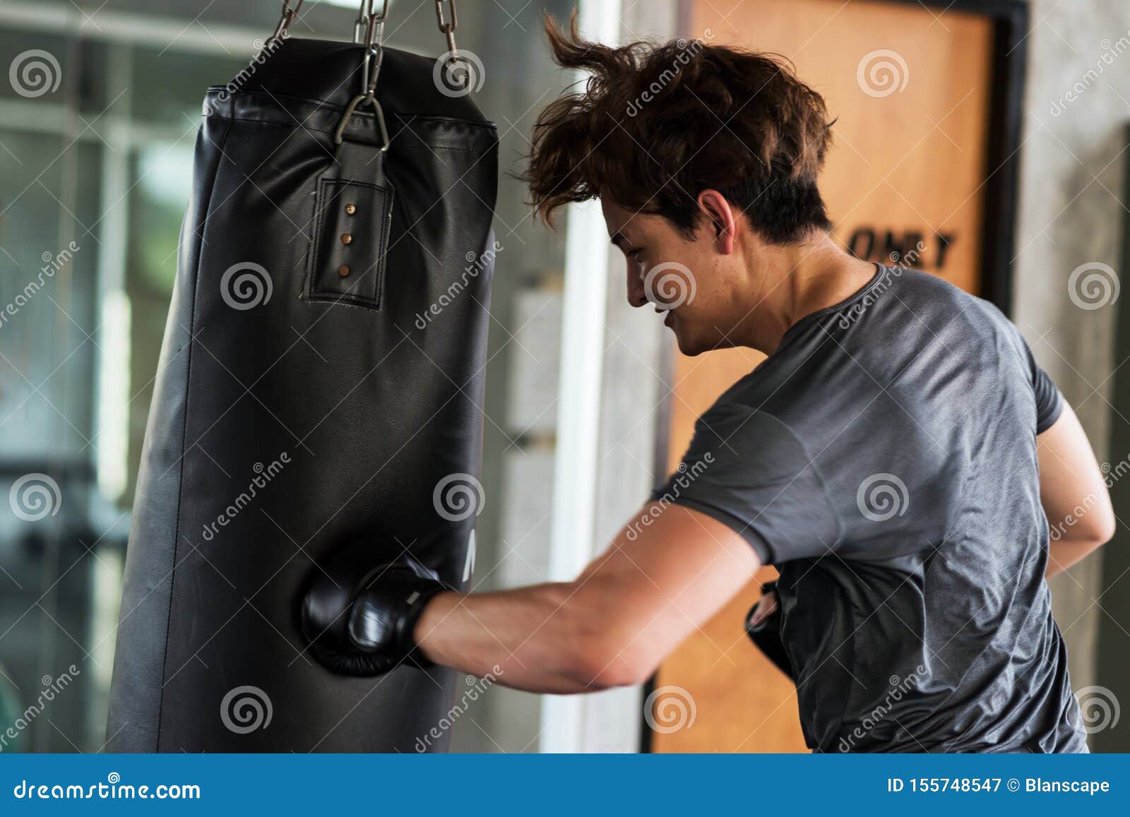 Man Punch Big Bag At Fitness Gym Stock Image Image of