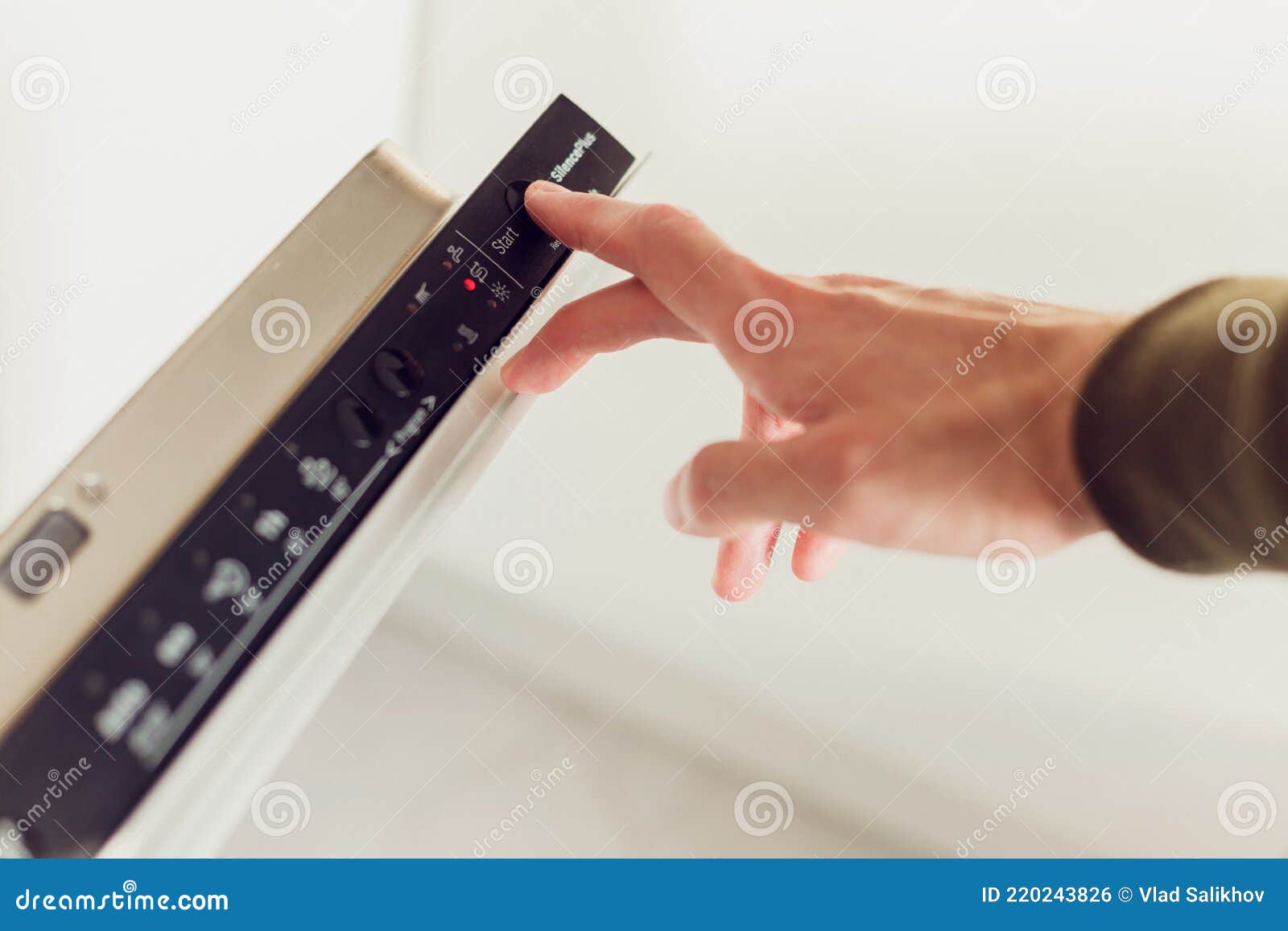 Man Pushing Start Button on the Control Panel of the Dishwasher. Stock Photo Image of person