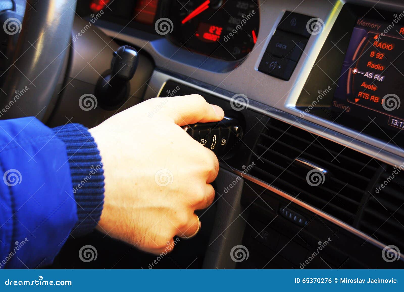Man Putting Car Key To the Keyhole, Starting the Car Stock Photo