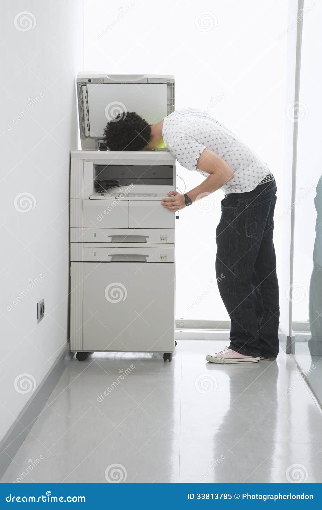 Man Putting His Head In Copy Machine In Hallway Royalty 