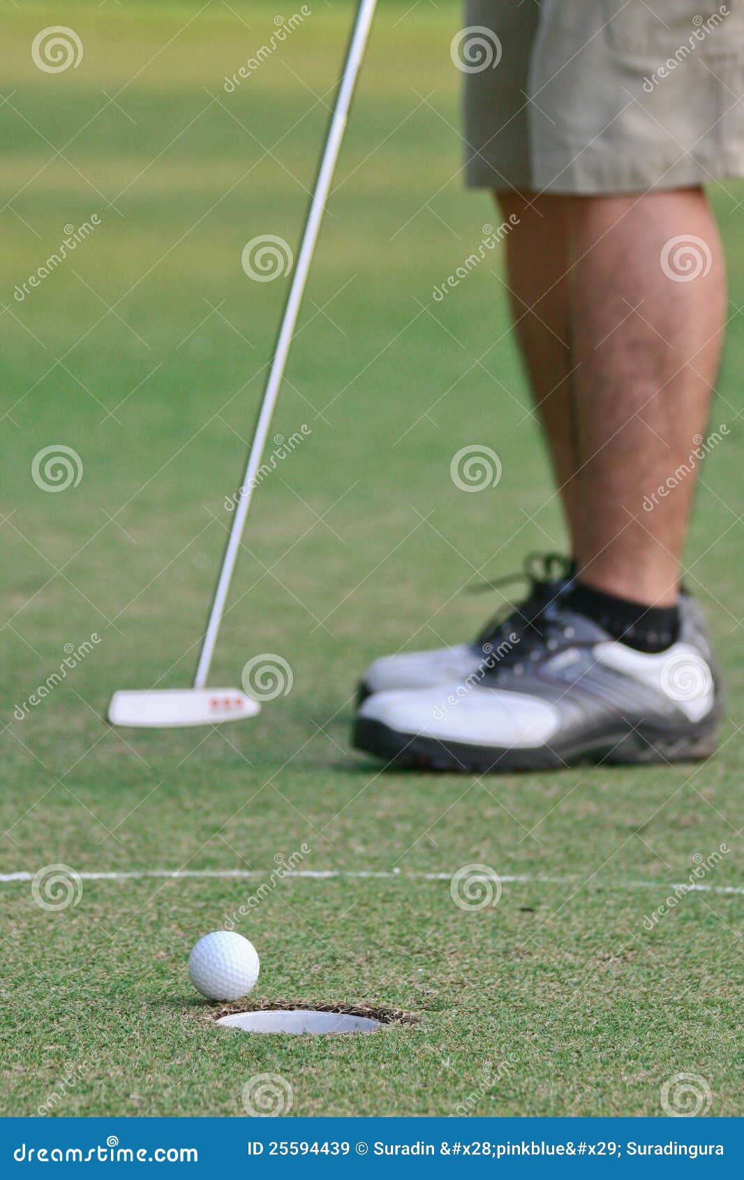 A man putts a golf ball stock image. Image of spring 25594439