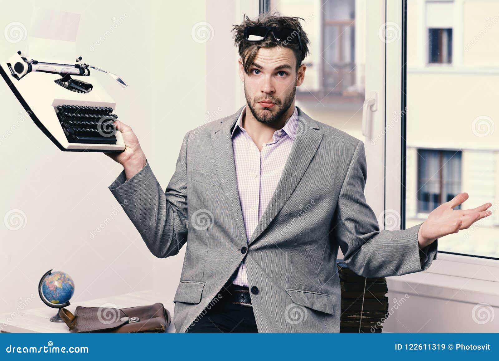 Man with Puzzled Face Types Business Report. Young Author or Editor Holds  Old Typewriter on Window Background Stock Image - Image of document,  letter: 122611319