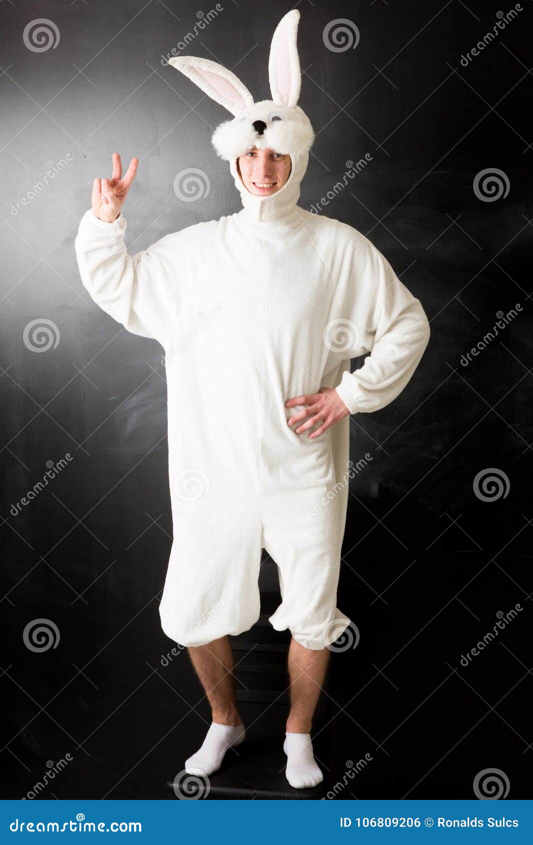 man in a rabbit costume showing a peace sign