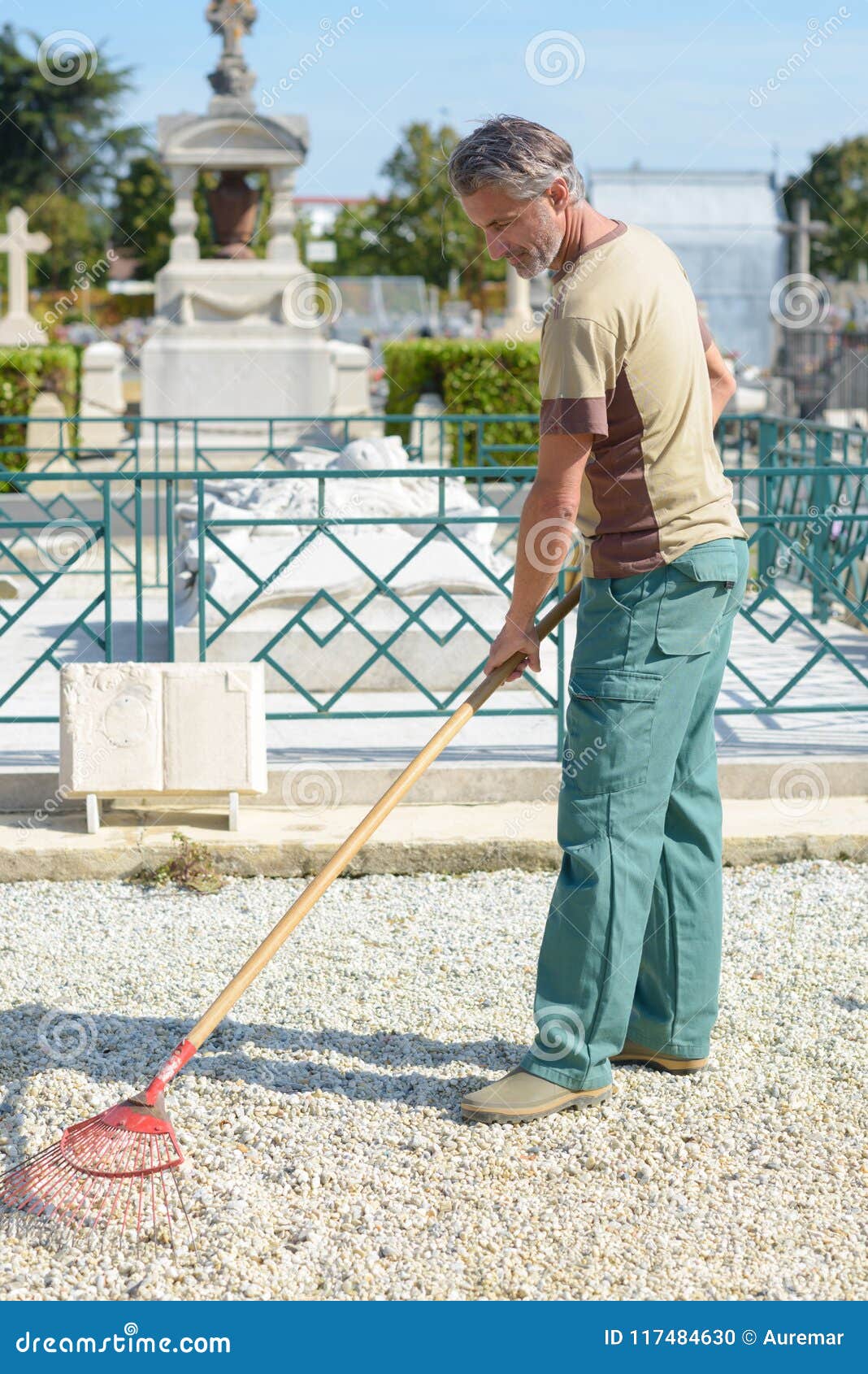 Man Raking Gravel in Cemetery Stock Photo Image of burial, garden