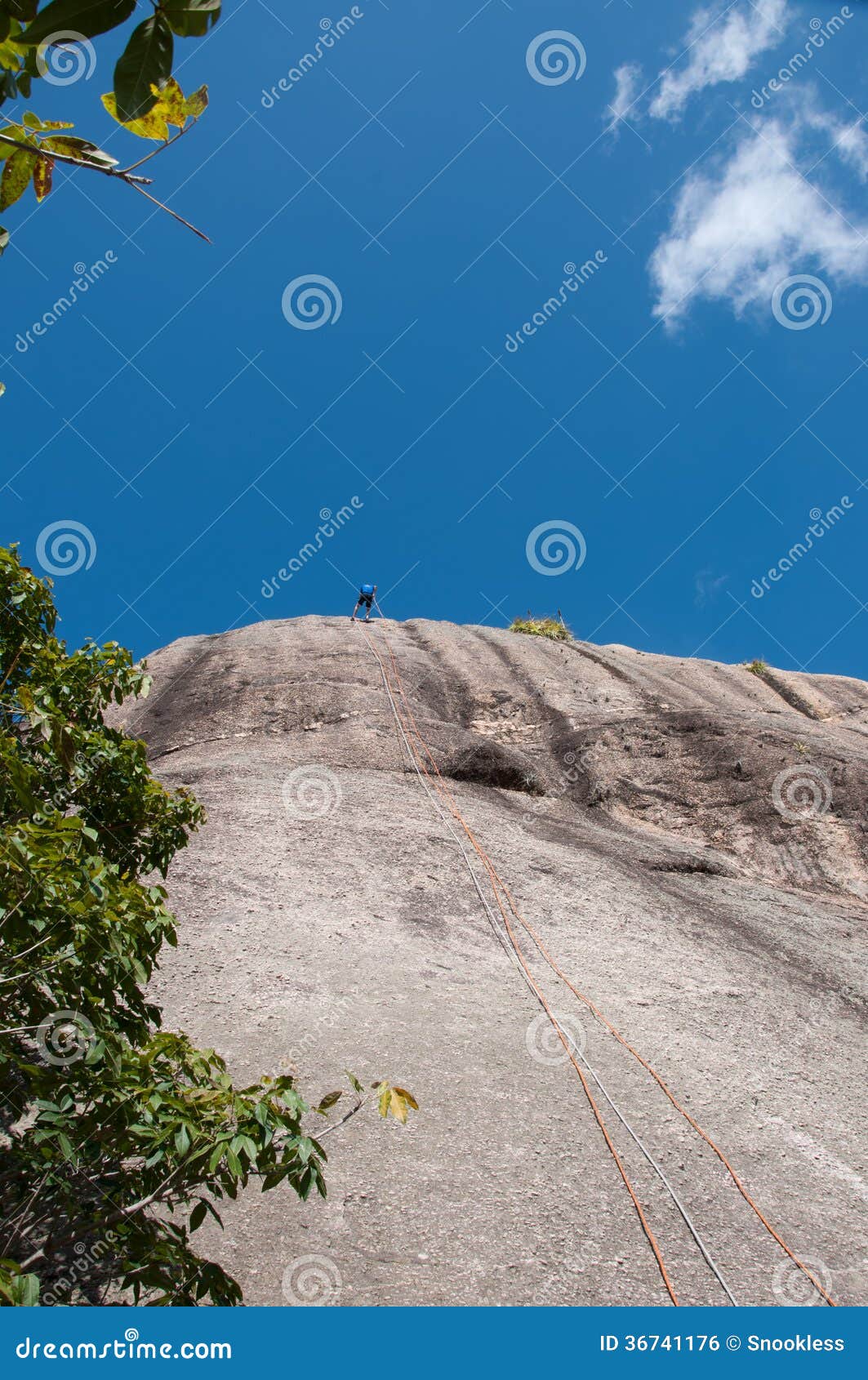 Man Rappelling from Cliff stock photo. Image of adrenalin 36741176