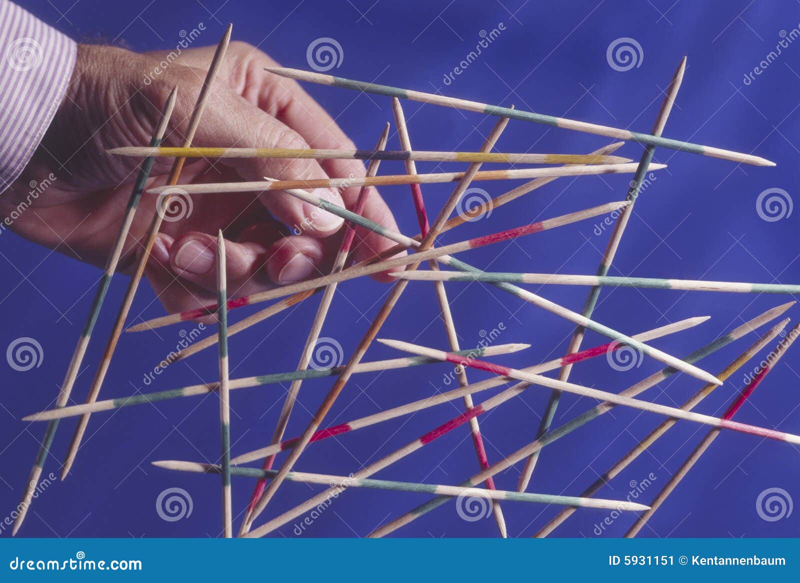 Man Reaching for Pickup Sticks Stock Image Image of potential, leader