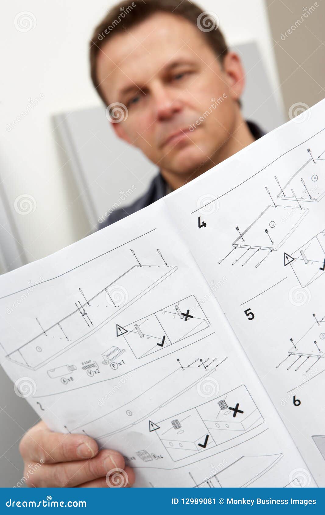 man reading assembly instructions for flat pack