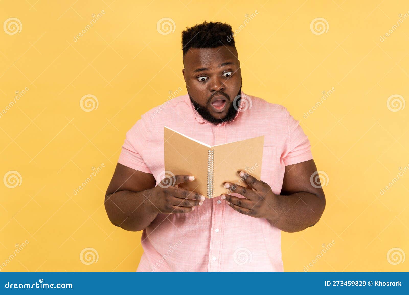Man Reading Book with Surprised Expression, Amazed by Story Being