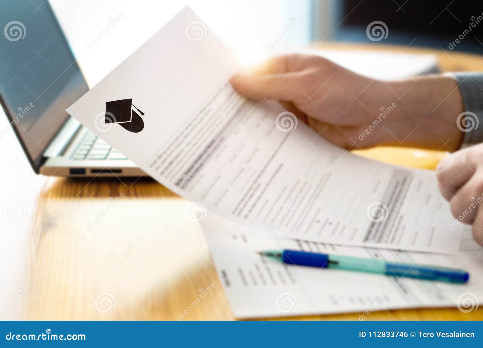 man reading college or university application or document.