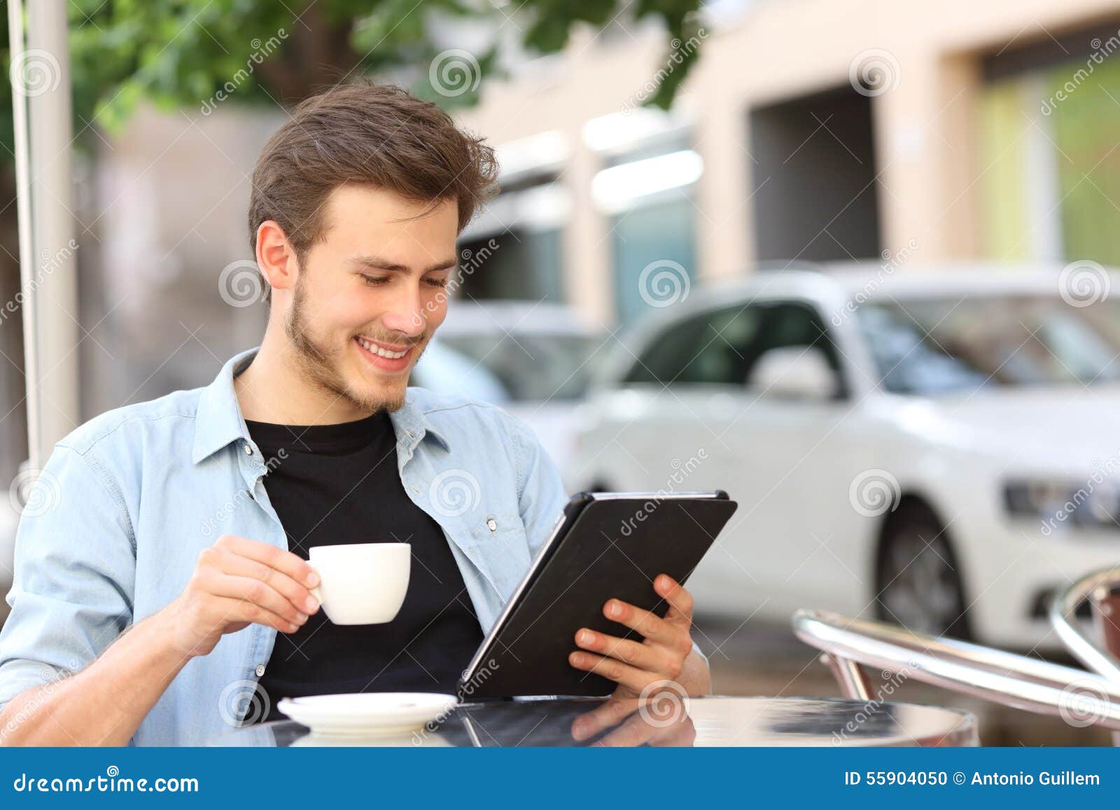 man reading an ebook or tablet in a coffee shop