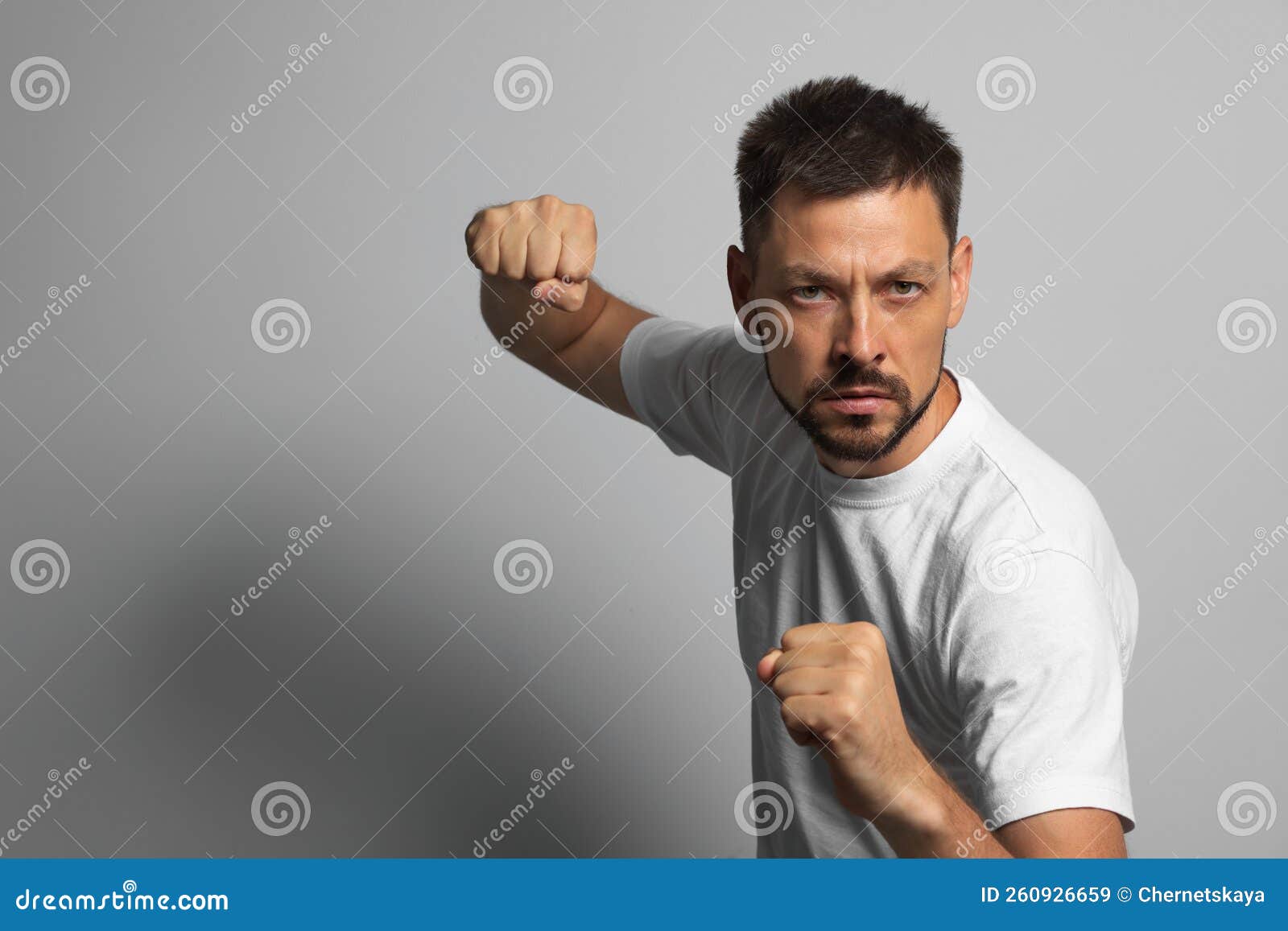 Man Ready To Fight on Grey Background, Space for Text Stock Image