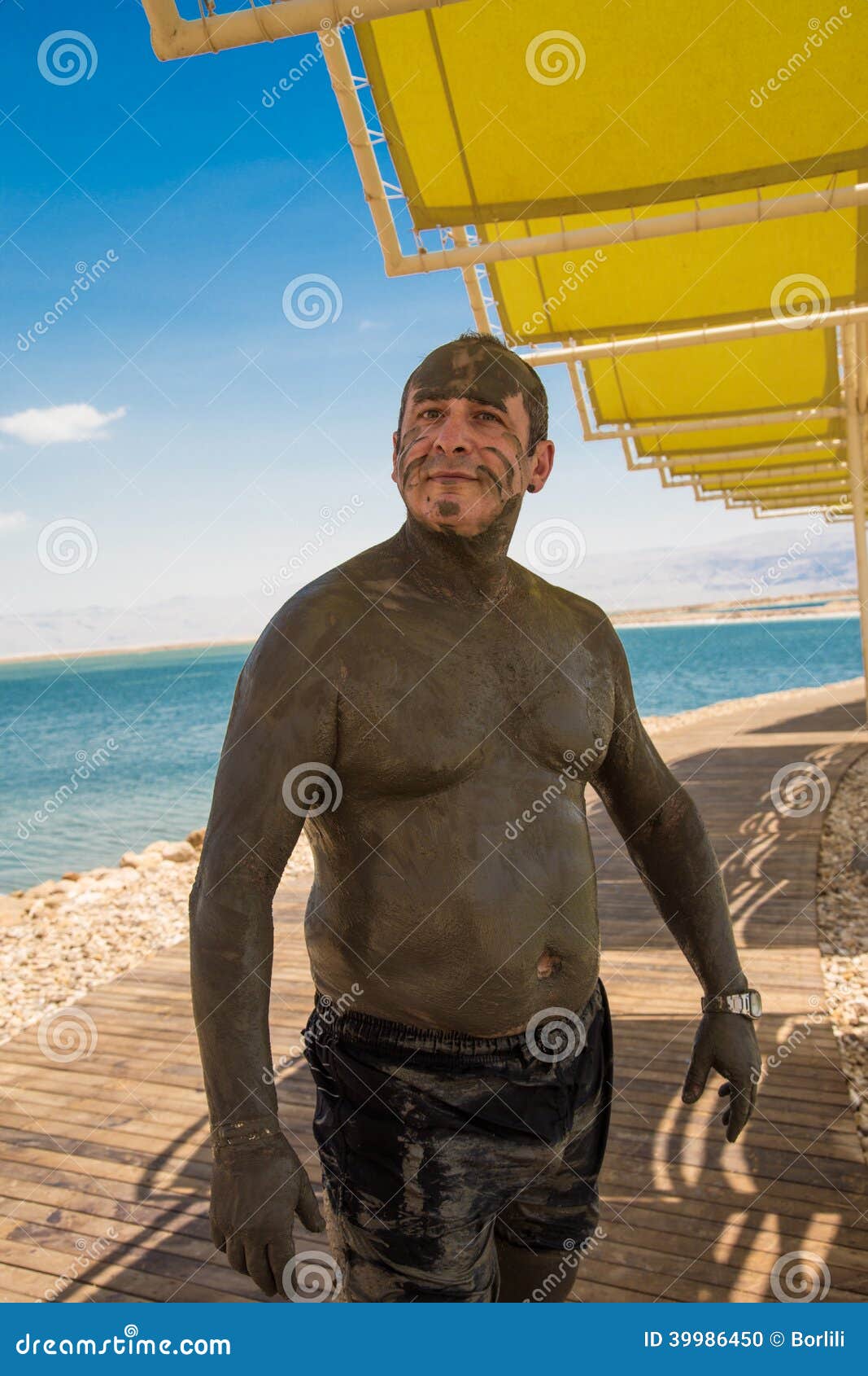 Man receives mud treatment stock photo. Image of coast 39986450