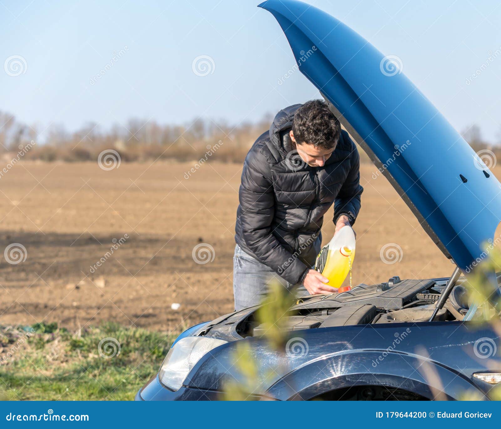 The Man Refills the Windscreen Washer Fluid Stock Photo Image of