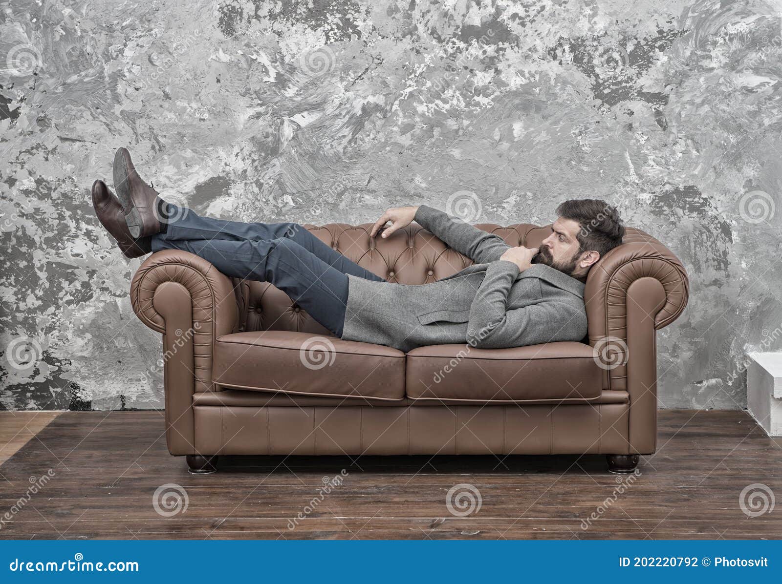 Man Relaxing on Luxurious Leather Couch, Thoughtful Mood Concept Stock ...