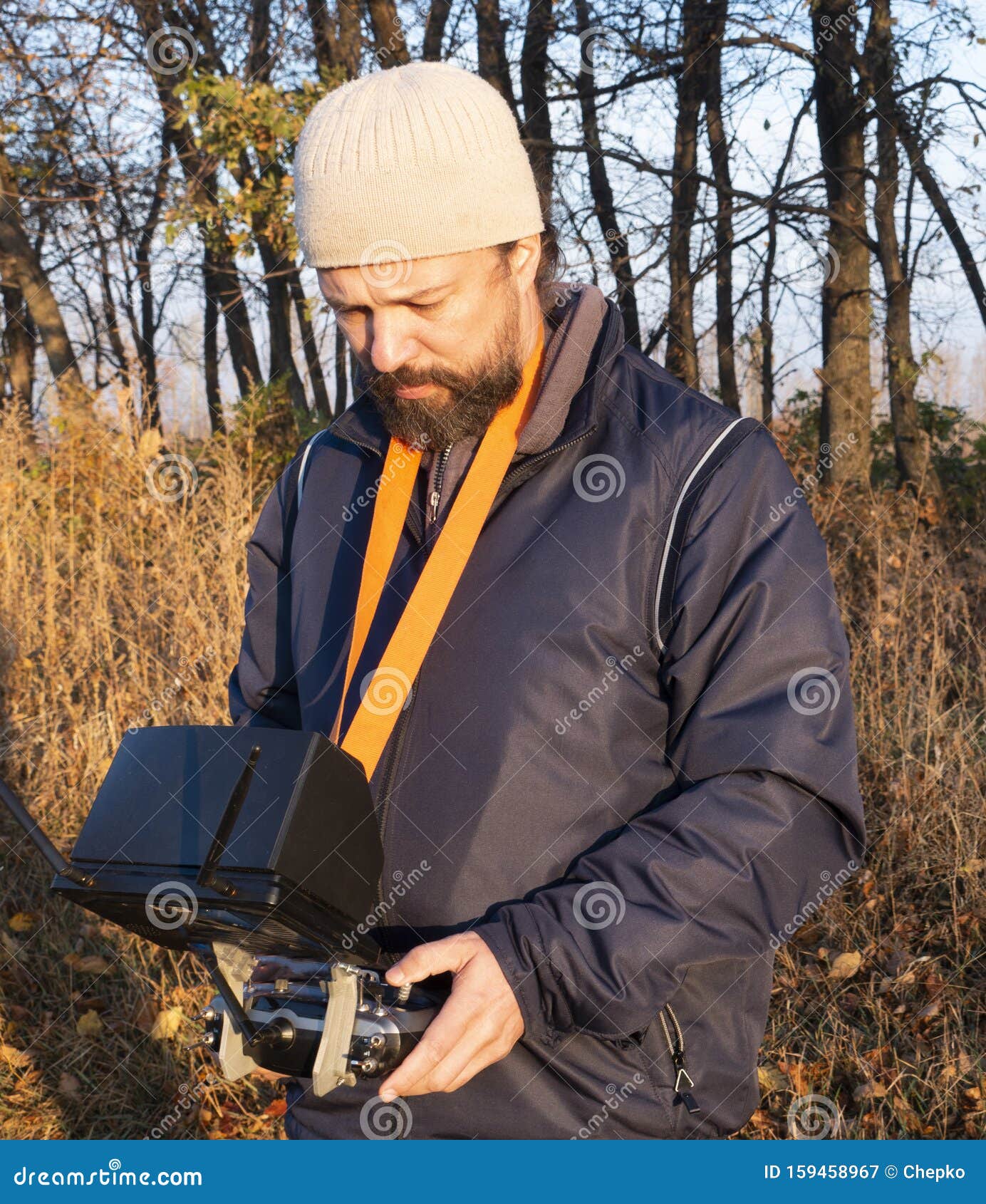 man with remote control a dron in the park