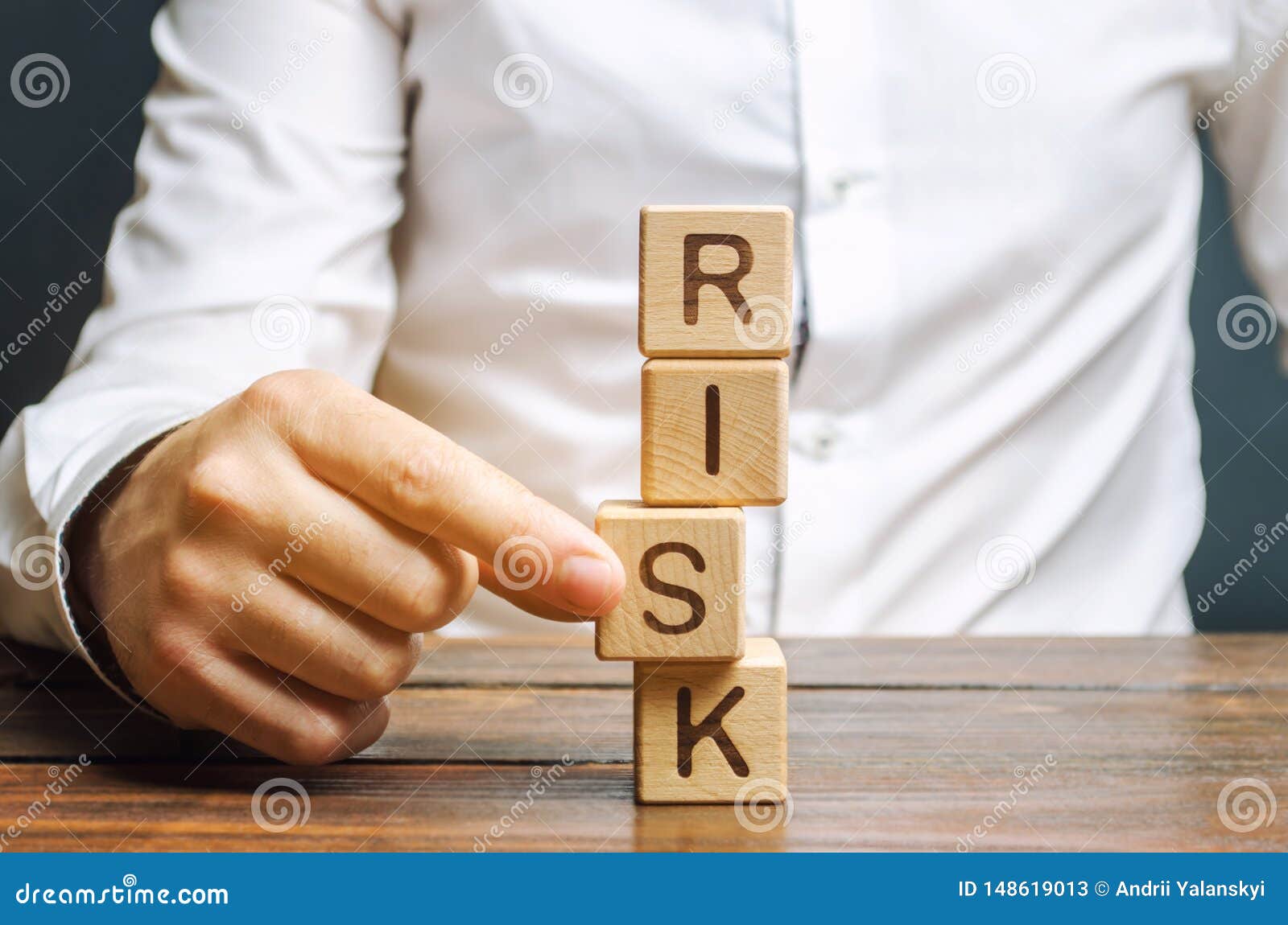 man removes blocks with the word risk. the concept of reducing possible risks. insurance, stability support. legal protection of