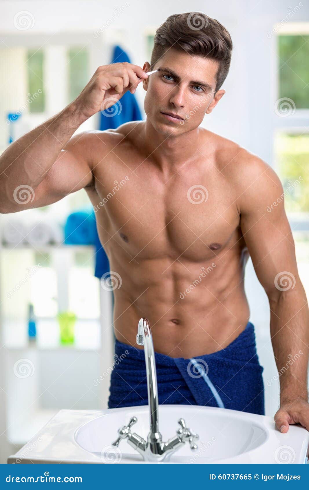 man removing eyebrow hairs with tweezing