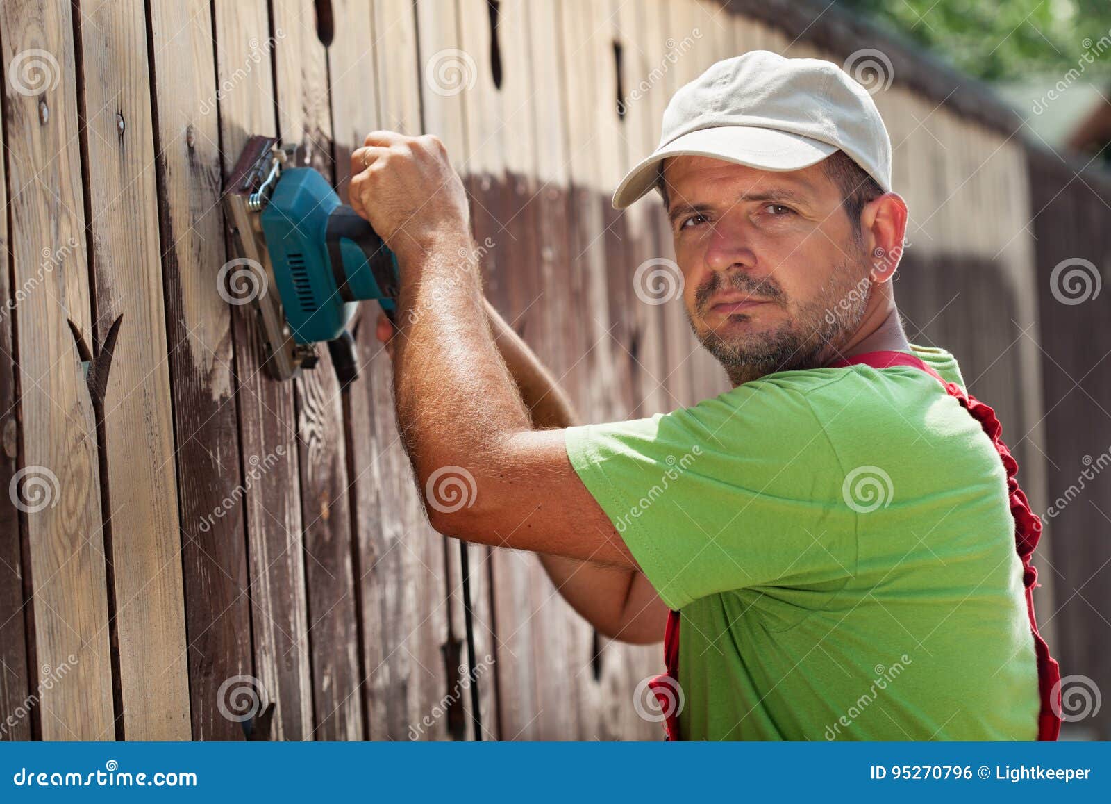 Man Removing Old Cracked Paint from a Fence Stock Photo Image of
